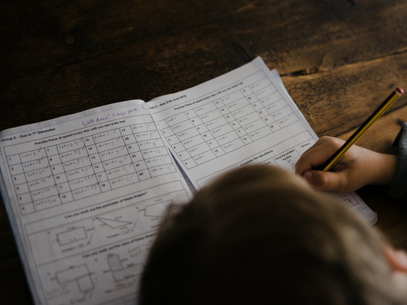 A young student thinking carefully over their schoolwork
